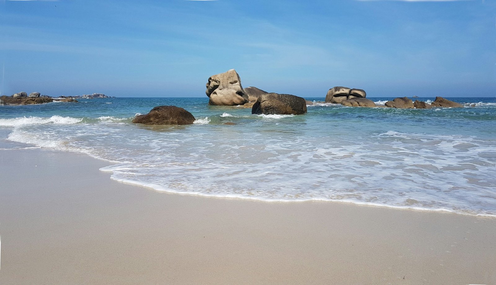 brown rock formation on sea shore during daytime